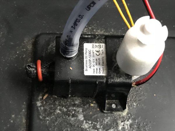 pump and water level sensor switch assembly glued to bottom of diy self watering pot reservoir